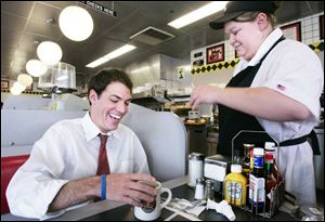 Ben Konop, left, chats with Jennifer Brandon of Toledo at the Waffle House in Sylvania, one of his regular haunts.