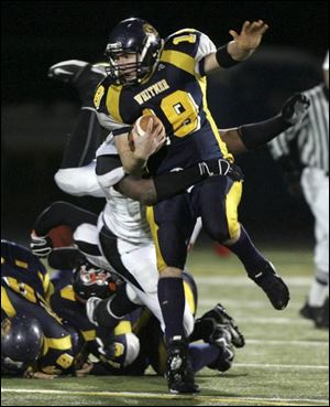 Whitmer quarterback Donnie Dottei is tackled by Massillon Washington's Emery Saunders after gaining a first down.