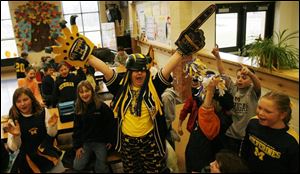 Monroe Road Elementary technology specialist Tina Mortemore pumps up Michigan fans while on the other side of the cafeteria.