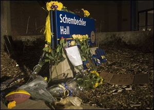 Flowers and memorials are left outside Schembechler Hall, Michigan s football practice facility named after the late coach.