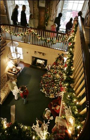 Visitors to the Manor House at Wildwood Metropark take in the holiday decorations from the main staircase of the 68-year-old mansion. The former Stranahan home s annual Christmas display, in its 31st year, runs through Sunday.
