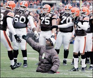 Bobby Martin, who was born without legs, high-fives the Browns' Matt Stewart. Martin, who played on special teams at Dayton Colonial High School, was an inspirational guest of the team.
