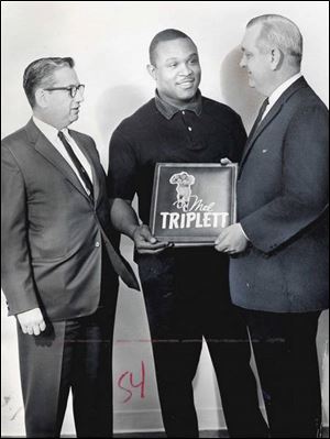 Rothman, left, is seen here with former UT football star Mel Triplett, center, and former Blade artist Charles Beyer in 1964.