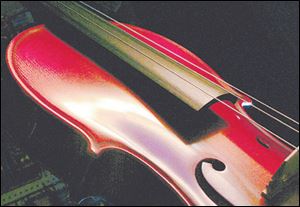 Gentle curves accent the beauty of a violin at Dr. Dave s Band Aide.