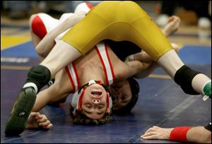 Mitch Weber of Wauseon, in white, arches his back while in the grip of Lexington s John Gould in the 103-pound class at the Jim Derr Memorial tournament yesterday.