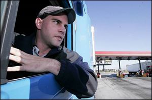 Tractor-trailer driver Matt Frey
passes through a truck stop in Stony Ridge during a recent delivery run.
