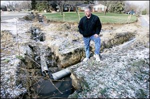 Drainage ditches like the one viewed by Mike Malone are the topic on concern for him and his Green Hills neighbors.