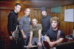 Robert Golden, left, Travis Montgomery, Kyle Kleeberger, Mark Montgomery, and Tim Strausbaugh were not allowed to perform as their Christian rock group, Pawn, at an anti-drug rally at Rossford High School. Supporters sued over the board's December, 2004 decision.