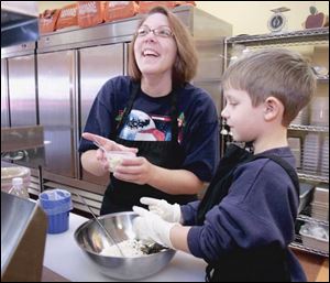 Michelle Miarer and son Makade, 5, mix up a batch of ginger snaps at Supper Thyme USA in Findlay.