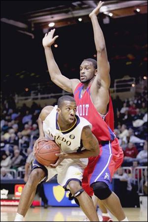 The Rockets  Jerrah Young looks for a shot against Detroit s Ryvon Covile, who led the Titans in scoring with 21 points.
