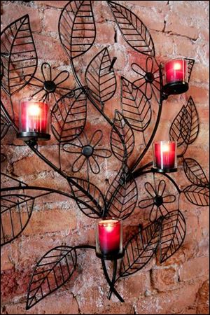 Candles in a decorative sconce can brighten a wall.