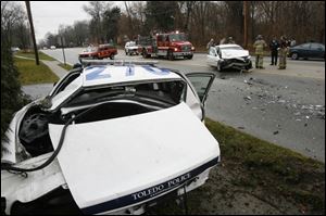 Toledo police and fire departments investigate the scene of a collision involving a police cruiser.