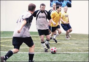 The Black Swamp soccer team, including Mark Hardy, second from left, takes on the Perrysburg Yellow Jackets at Gold Medal. 
