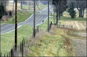 Bobby Roby's car crashed through the opening between the two foreground telephone poles after veering to avoid striking a decoy deer left on County Road 144 by a group of teenagers. 