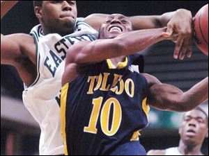 Kashif Payne gets fouled by Eastern Michigan's Justin Dobbins as he drives to the hoop in the second half against the Eagles.