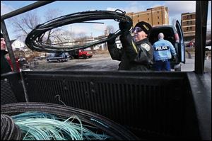 CSX Transportation Police Special Agent Dave Chase loads up copper wire that was used in a sting operation with the Toledo Police Department at Lagrange Metals on Utica Street near Lagrange Street. 