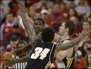 Ohio State's Greg Oden looks to pass against Sean Gorney, right, and Tyler Smith of Iowa.