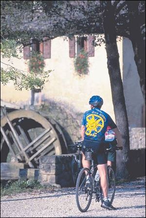A tourist traveling with the Culinary Bike Riders pauses during a trip through central Italy.