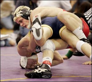 Eric Cubberly of Eastwood wraps up Evan Roth of Whitmer in the 152-pound final at the Mary Kerr Memorial Tournament at Waite. Cubberly, the event's most valuable wrestler, won 15-0. 