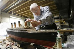 Jacques Rietzke, 82, a master model shipbuilder, works on his model of the Titanic. He says it is about 90 percent complete.