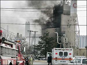Firefighters work on the fire at the Kuhlman Corp. this afternoon.