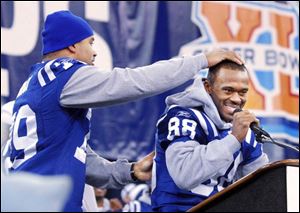 Horseplay is natural among Colts, especially after a Super Bowl victory. Tackle Raheen Brock rubs the head of receiver Marvin Harrison at a rally last night in the RCA Dome.
