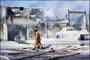 Perkins Township firefighters keep water going on a Hermes Dairy Farm structure.