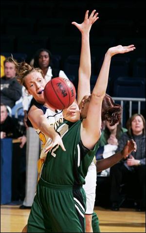 Toledo's Savannah Werner goes around Ohio University's Chandra Myers with a pass in the first half of the Rockets' victory at Savage Hall.