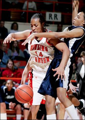 The Falcons' Carin Horne is fouled by Akron's Jessie Crooks.