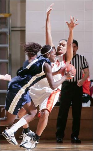 Akron s Riana Miller, from Northview, is fouled on a drive by Bowling Green s Amber Flynn. Miller led Akron with 12 points.

