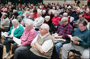 A large crowd hears about the potential financial impacts of a merger proposal for Sylvania and Sylvania Township.