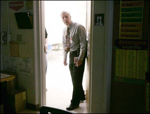 Gary Keller, principal of Kenwood Elementary in Bowling
Green, inspects classrooms during a lockdown drill to ensure students and teachers are following proper procedures.