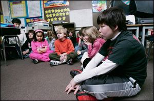 Third-grade teacher Mary Ann Hoare, far left, and her students at Kenwood Elementary in Bowling Green sit quietly during a school lockdown drill.