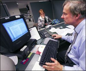 Jim Hojnacki works on the return of Tracy Eaker, of Toledo, at the IRS office downtown.