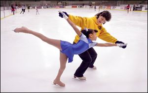 Marrisa Avery learns correct from coach SHelly Bressler at the Bowling Green State University ice rink.