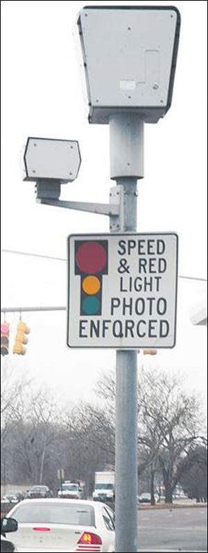 Automated cameras at select intersections across Toledo have generated $1.4 million for the city since 2001.