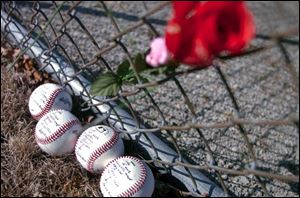 Baseballs with memorial messages and names of the
four Bluffton University baseball players who died in Friday s bus crash in Atlanta lie next to a fence near the team s playing diamond in Bluffton.