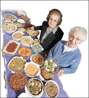 Mary Markham and Ann Mulopulos with some of their potluck dishes.