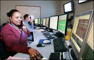 From left, Val Brooks and M.J. Hill, surveillance specialists for Buckeye CableSystems, monitor
its network from a control room. The local company has been in business since 1965.