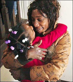 Latisha Miller hugs her daughter Aireana McClellan.