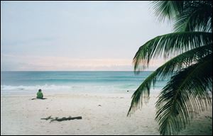 A tourist watches the water in Tulum, Mexico.