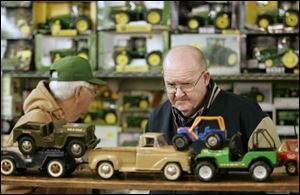 Thomas Fields of Clyde, Ohio, who has a collection of about 200 toy cars, trucks, and tractors, examines a display at the toy and doll show. Dealers from several states participated.