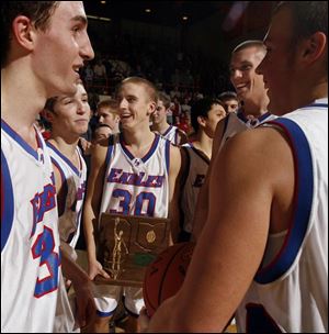 Liberty-Benton's T.J. Recker holds the trophy after the Eagles defeated St. Henry in a Division III boys regional final.