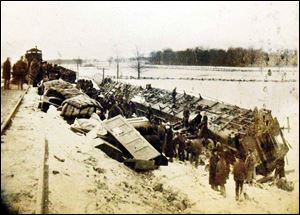 Charred railcars, lie on their sides at the scene of the 1901 collision when the Wabash Railroad s westbound No. 13 collided with Wabash No. 4 passenger train 3 miles outside of Sand Creek. Nearly 100 northern Italian immigrants, who were on the westbound train headed for mining jobs, perished in the crash. 