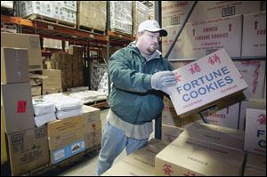 Doug Saar pulls boxes from the Glass City Food Service warehouse for delivery to a customer. The firm, in business nearly five decades, has estimated annual revenues of $14 million.