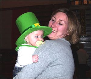 Megan Lokken holds her little leprechaun, her daughter Katie, at the Order of the Hibernian St. Patrick s Day Festival.