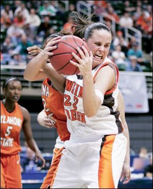 Bowling Green s Ali Mann rips down one of her 13 rebounds
during the second half of the Falcons  opening-round victory.