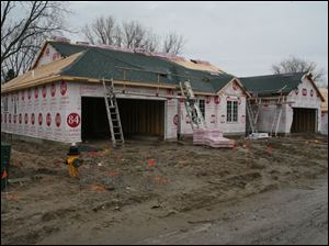 biz build25p  3_21_2007 photo by herral long  workers   were  off  because of rain  note the weather was bad and there was no work going on outside  i did run into the builder Dave Filas   419 360 8815  -- and they were working inside one of the homes  putting down carpet.  Need stand-alone art for Sunday business section. Get various  shots of workers-- hopefully -- building houses at the new subdivison,  the Village at Laurel Hills ______________