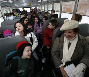 Blade columnist Mary Alice Powell chats as the bus heads for an Adrian school.