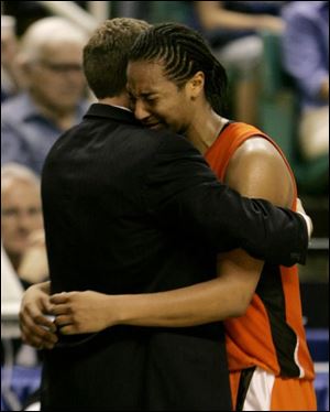 Bowling Green's Carin Horne is consoled by assistant coach Kevin Eckert late in the second half of their 67-49 loss to Arizona State in a regional semifinal of the NCAA women's basketball tournament in Greensboro, N.C., Saturday, March 24, 2007.